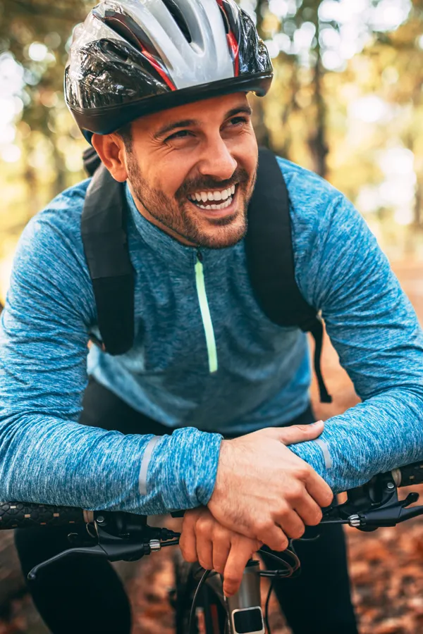 Adrenal-Hormone-Disorder-Treatment A smiling man getting ready for a cycling trip. Get treatment for adrenal hormone disorder from Dr. Donna Diamond in Louisville/Boulder.
