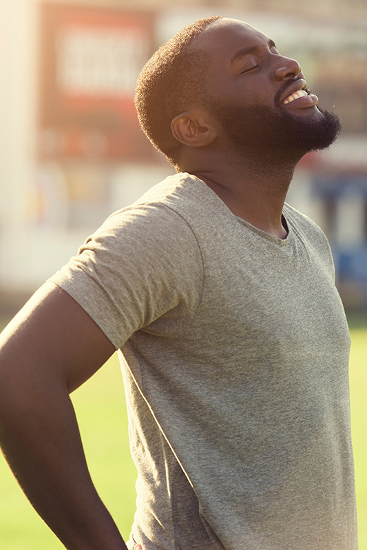 Allergic-Rhinitis-Treatment A black man in a t-shirt smiles and raises his face to the sun due to relief from allergies. Get treatment for allergic rhinitis from Dr. Donna Diamond in Louisville/Boulder.