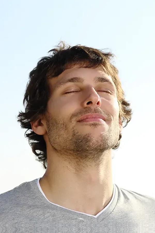 Depression-Treatment A man with closed eyes and a smile turns his head to the sky calmly. Get treatment for depression from Dr. Donna Diamond in Louisville/Boulder.