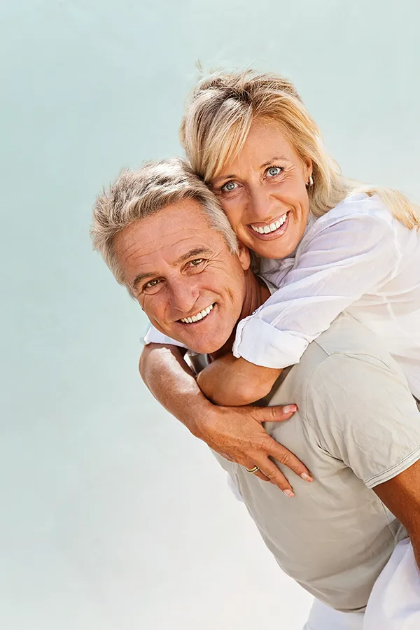 Food-Allergies-Treatment-1 A happy mature couple having fun - the husband is carrying his wife on his back. Get treatment for food allergies from Dr. Donna Diamond in Louisville/Boulder.