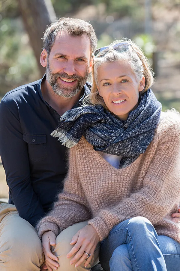 Inflammotory-Bowel-Disease-IBD-Treatment Happy middle-aged couple outdoors wearing cozy fall clothes, smiling calmly. Dr. Donna Diamond is a compassionate IBD specialist in Louisville/Boulder supporting long-term gut health and symptom relief through functional medicine.