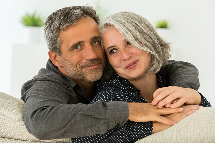 Integrative-Medicine-Clinic A middle-aged couple embracing on their couch. Get integrative medicine services from Dr. Donna Diamond in Louisville/Boulder.