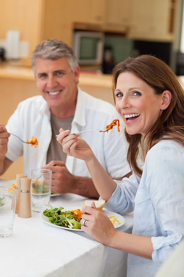 Leaky-Gut-Syndrome-Treatment Improve digestion with Dr. Donna Diamond's Functional Medicine for Leaky Gut Syndrome care in Louisville/Boulder, featuring a happy couple enjoying a nutritious lunch at home.