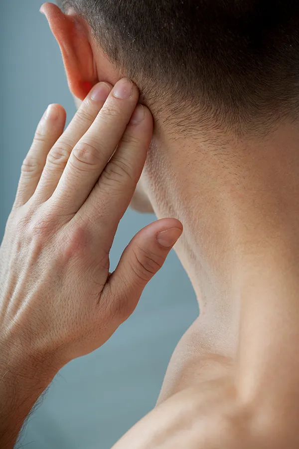 Lymphatic-Drainage-Massage-Treatment A man touches his lymph nodes. Get lymphatic drainage enhancement from Dr. Donna Diamond in Louisville/Boulder.