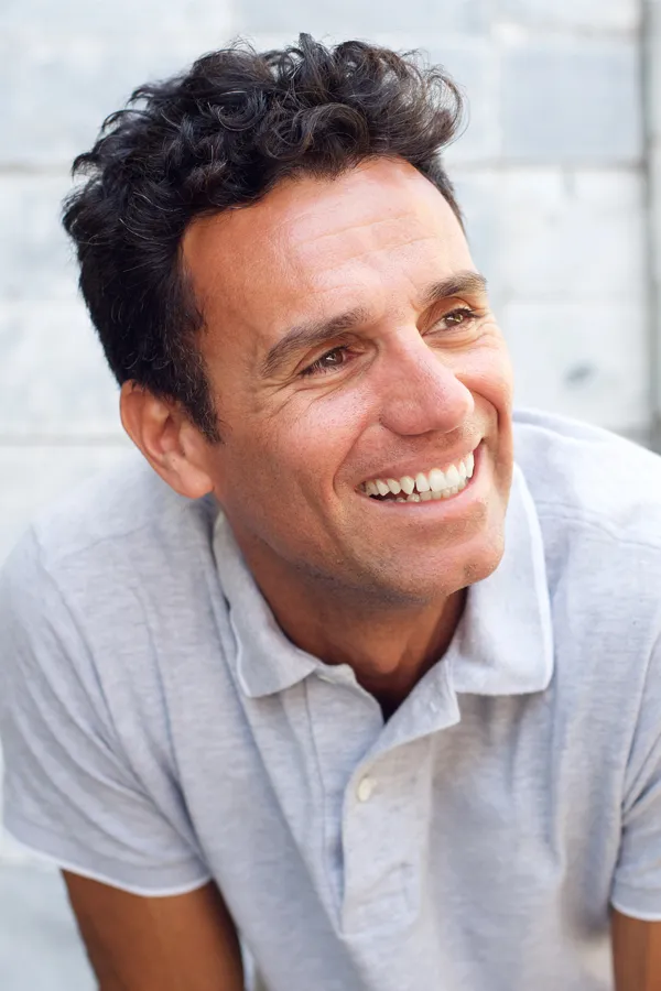 Lymphatic-Facial-Treatment A middle-aged man with a healthy face smiling. Get lymphatic enhancement facial from Dr. Donna Diamond in Louisville/Boulder.