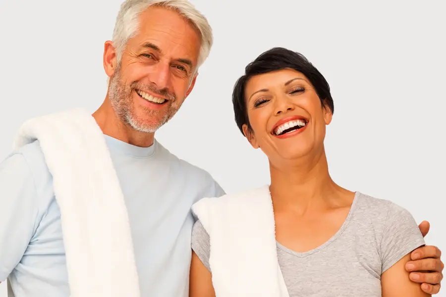 PEMF-Therapy-Clinic A mature man and woman with towels draped over their shoulders smiling after a work out. Get PEMF Pulsed Electromagnetic Field therapy from Dr. Donna Diamond in Louisville/Boulder.