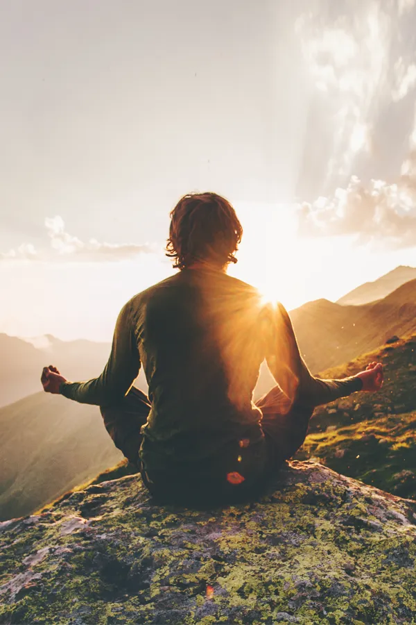 PTSD-Treatment A man meditating on a mountaintop. Get treatment for PTSD from Dr. Donna Diamond in Louisville/Boulder.