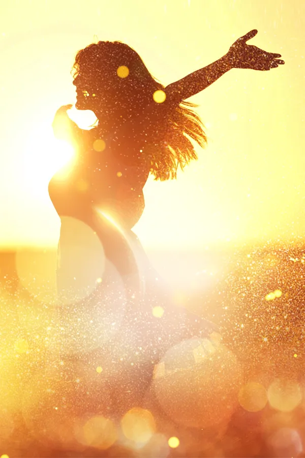 Salt-Therapy-Treatment A woman raises her arms in a sun-speckled field. Get salt therapy from Dr. Donna Diamond in Louisville/Boulder.