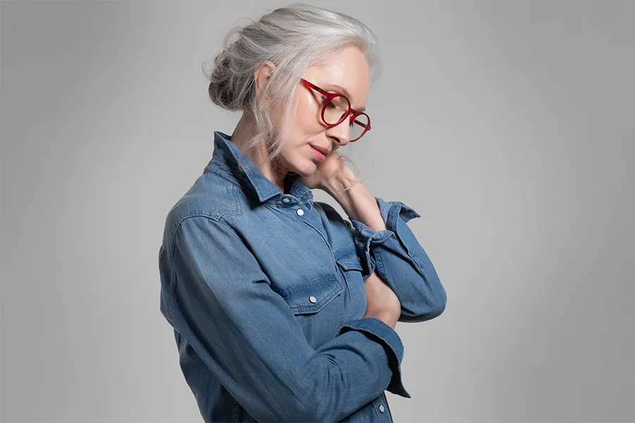 Stress-and-Burnout-Clinic A middle-aged woman rubs her neck from stress. Schedule treatment for stress and burnout from Dr. Donna Diamond in Louisville/Boulder.