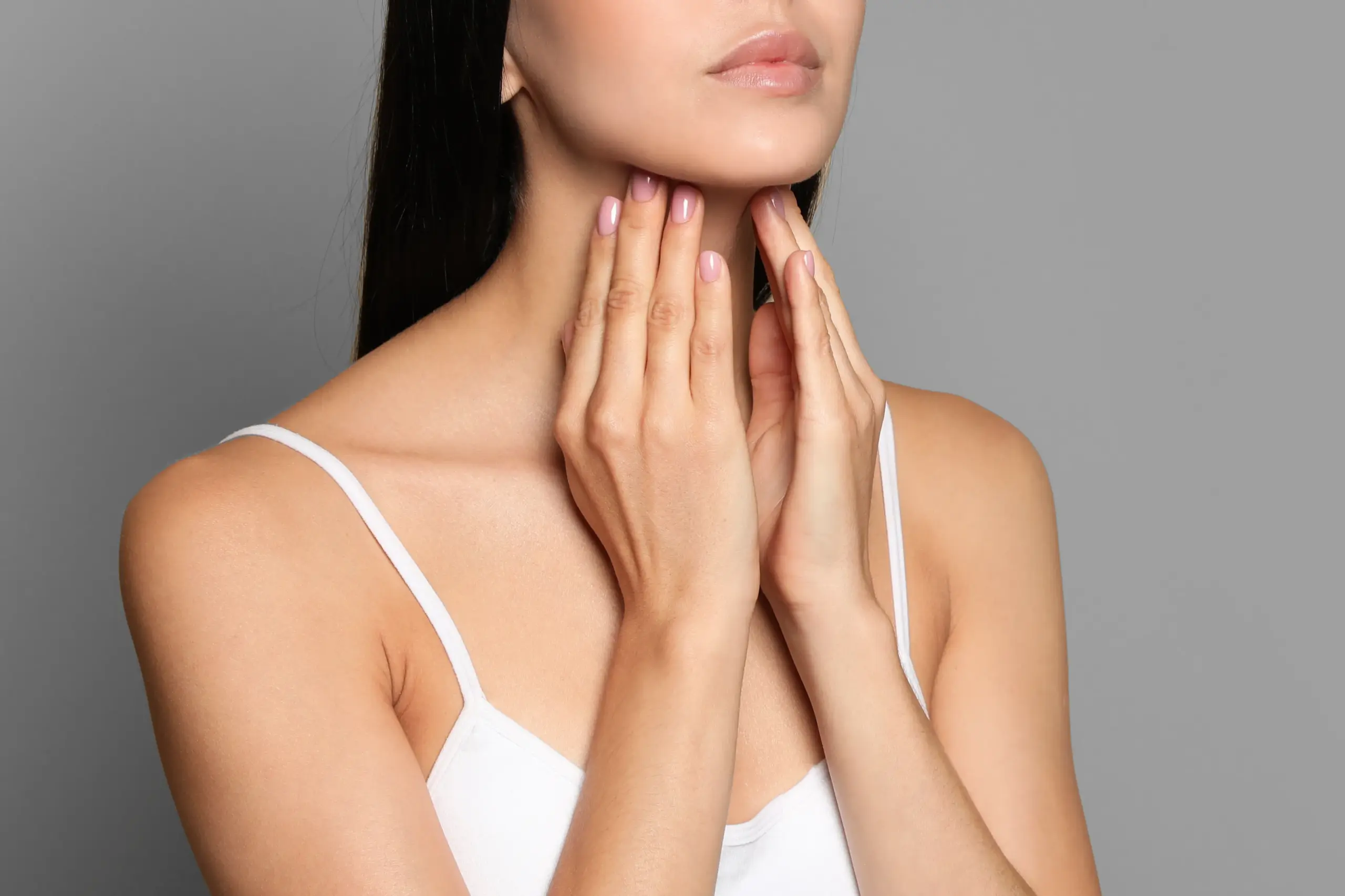 Thyroid-Doctor A woman in a white tank top touches her neck looking for signs of thyroid disorder. Get help for thyroid disorders from Dr. Donna Diamond in Louisville/Boulder.