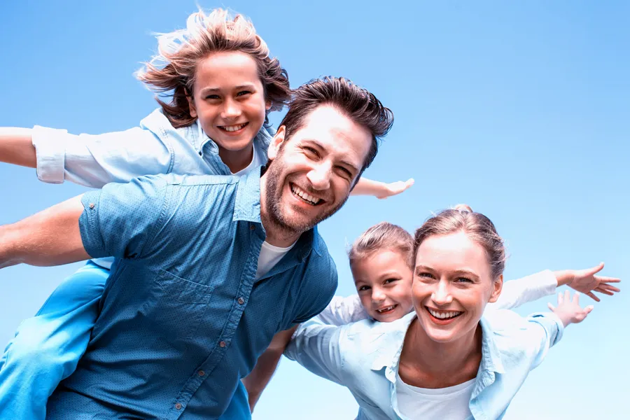 Whole-Family-Primary-Care-Clinic A family with outstretched arms playing under a blue sky. Get Whole Family Primary Care from Dr. Donna Diamond in Louisville/Boulder.
