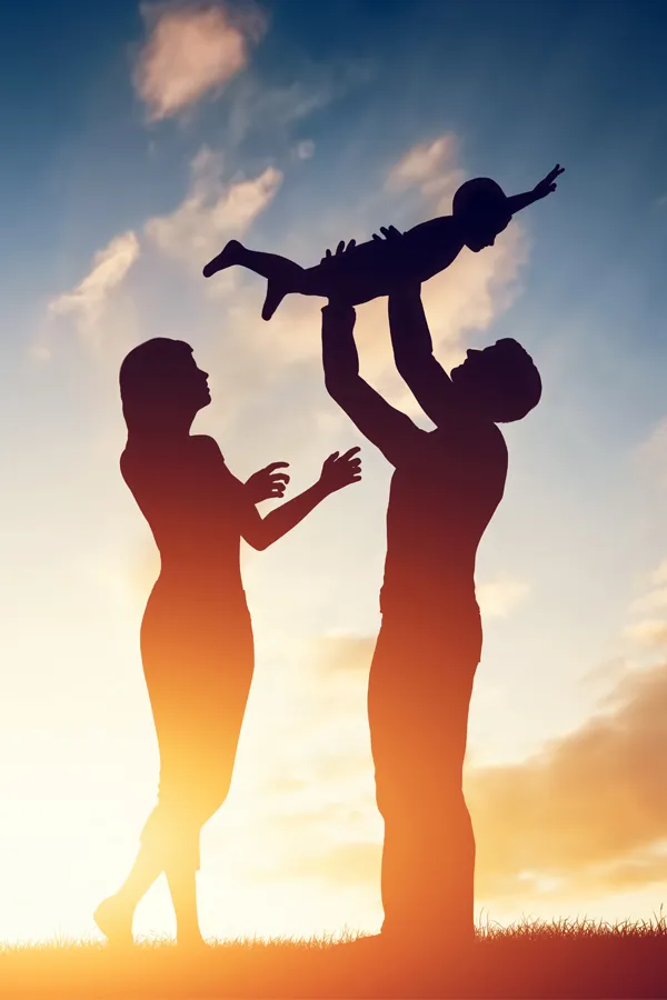 Whole-Family-Primary-Care-Treatment Silhouette of a happy family with a child lifted into the air in the sunset. Get Whole Family Primary Care from Dr. Donna Diamond in Louisville/Boulder.